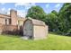 Backyard storage shed featuring double doors and wooden ramp at 1641 Regency Dr, Burlington, NC 27215