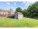 Backyard storage shed, fenced yard, brick patio at 1641 Regency Dr, Burlington, NC 27215