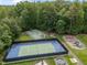 Aerial view of tennis and basketball courts next to a playground in a lush, green community at 1702 Mcrae Pl, Hillsborough, NC 27278