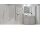 Bright bathroom with a white vanity, tub with shower and tile flooring at 1702 Mcrae Pl, Hillsborough, NC 27278