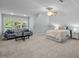 Spacious bedroom with a sitting area, large window, and neutral decor, creating a serene atmosphere at 1702 Mcrae Pl, Hillsborough, NC 27278