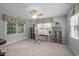 Cozy bedroom with a ceiling fan, built-in shelving, and large windows offering ample natural light at 1702 Mcrae Pl, Hillsborough, NC 27278