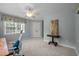 Bright, carpeted bedroom featuring a ceiling fan, generous natural light, and a serene, neutral color scheme at 1702 Mcrae Pl, Hillsborough, NC 27278