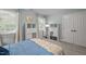 Well-lit bedroom with a queen bed and cube storage on each side of a window and a large closet at 1702 Mcrae Pl, Hillsborough, NC 27278
