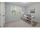 Bright bedroom featuring a white desk with a chair and a window providing natural light at 1702 Mcrae Pl, Hillsborough, NC 27278