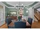 Inviting dining room with hardwood floors, traditional chandelier, and view into the kitchen at 1702 Mcrae Pl, Hillsborough, NC 27278