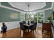 Elegant dining room with hardwood floors, bay window, and traditional chandelier at 1702 Mcrae Pl, Hillsborough, NC 27278