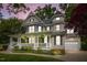 Elegant two-story home featuring a welcoming front porch and a well-maintained lawn at 1702 Mcrae Pl, Hillsborough, NC 27278
