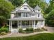Charming two-story home with a large, inviting front porch and beautifully landscaped yard at 1702 Mcrae Pl, Hillsborough, NC 27278