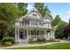 Elegant two-story home featuring a welcoming front porch and a well-maintained lawn at 1702 Mcrae Pl, Hillsborough, NC 27278