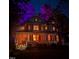 Elegant two-story home illuminated with eerie purple and orange lights, complemented by a welcoming front porch at 1702 Mcrae Pl, Hillsborough, NC 27278