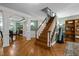 Welcoming foyer featuring hardwood floors, staircase with white railing, and decorative columns at 1702 Mcrae Pl, Hillsborough, NC 27278