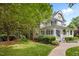 Charming two-story home with a welcoming front porch and beautifully landscaped front yard at 1702 Mcrae Pl, Hillsborough, NC 27278
