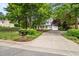 Beautiful home featuring a well-manicured lawn, mature trees, and a welcoming front porch at 1702 Mcrae Pl, Hillsborough, NC 27278