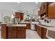 Beautiful kitchen boasts custom wood cabinetry, stainless steel appliances, and a seamless flow to the living area at 1702 Mcrae Pl, Hillsborough, NC 27278