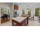 Bright eat-in kitchen with an island, stainless refrigerator, and views of the breakfast nook and dining room at 1702 Mcrae Pl, Hillsborough, NC 27278