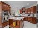 Modern kitchen featuring wooden cabinets, stainless steel appliances, and quartz countertops at 1702 Mcrae Pl, Hillsborough, NC 27278