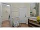 Well-lit laundry room with modern washer and dryer and ample storage; features hardwood floors and neutral tones at 1702 Mcrae Pl, Hillsborough, NC 27278