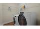 This well organized laundry room features a modern washer and dryer, and plenty of shelving for storage at 1702 Mcrae Pl, Hillsborough, NC 27278