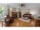 Inviting living room with a fireplace, hardwood floors, and comfortable seating arrangement at 1702 Mcrae Pl, Hillsborough, NC 27278