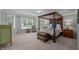 Spacious main bedroom with a four poster bed, large windows, and a neutral color palette at 1702 Mcrae Pl, Hillsborough, NC 27278
