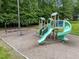 Community playground includes slides and swing set surrounded by greenery creating a fun outdoor space at 1702 Mcrae Pl, Hillsborough, NC 27278
