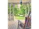 Cozy porch with rocking chair, offering a peaceful view of the green lawn and community at 1702 Mcrae Pl, Hillsborough, NC 27278