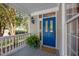 Close-up of a blue front door with glass panels, potted fern, and overhead lamp on the front porch at 1702 Mcrae Pl, Hillsborough, NC 27278