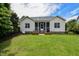 Manicured backyard with lush lawn, charming fence, and a cozy patio with outdoor seating at 18 Heathgreen Dr, Clayton, NC 27527