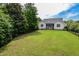 Spacious backyard featuring a well-maintained lawn, privacy fence, and views of the screened-in porch at 18 Heathgreen Dr, Clayton, NC 27527