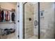 Bathroom showcasing a glass-enclosed shower with tiled walls, niche and a view into the spacious walk-in closet at 18 Heathgreen Dr, Clayton, NC 27527