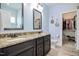 Bathroom with double vanity, granite countertops, a toilet, and a view into the walk-in closet at 18 Heathgreen Dr, Clayton, NC 27527