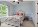 Cozy bedroom showcasing a decorative bed frame, bedside tables with lamps and a large window for natural light at 18 Heathgreen Dr, Clayton, NC 27527