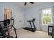 Bedroom featuring exercise equipment and a large window at 18 Heathgreen Dr, Clayton, NC 27527