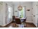 A stylish dining area with a round table, modern chairs, and decorative light fixture, with natural light at 18 Heathgreen Dr, Clayton, NC 27527