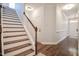 Entryway featuring hardwood flooring, staircase with carpet treads, and neutral walls for a welcoming first impression at 18 Heathgreen Dr, Clayton, NC 27527