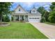 Charming home featuring a well-manicured lawn, inviting front porch, and a two-car garage at 18 Heathgreen Dr, Clayton, NC 27527