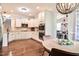 A bright kitchen with white cabinetry, granite countertops, stainless steel appliances, and hardwood flooring at 18 Heathgreen Dr, Clayton, NC 27527