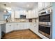 Beautiful kitchen with white cabinets, stainless steel appliances and hardwood floors at 18 Heathgreen Dr, Clayton, NC 27527