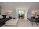 Spacious living area featuring a cozy seating arrangement, dining table and bright window at 18 Heathgreen Dr, Clayton, NC 27527