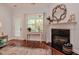 Bright living room with a fireplace, large window, and hardwood floors at 18 Heathgreen Dr, Clayton, NC 27527