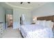 Spacious bedroom with a tray ceiling, en suite, and neutral decor at 18 Heathgreen Dr, Clayton, NC 27527