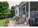 Outdoor patio featuring seating and a grill, leading to a screened porch for outdoor enjoyment at 18 Heathgreen Dr, Clayton, NC 27527