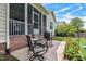 Charming patio with a seating area, planters, and access to the screened porch at 18 Heathgreen Dr, Clayton, NC 27527
