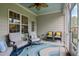 Relaxing screened porch featuring comfortable seating, a ceiling fan, and a tranquil outdoor ambiance at 18 Heathgreen Dr, Clayton, NC 27527