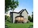 Inviting home back exterior featuring a screened-in porch and well-maintained yard with lush green grass at 1813 Bennett St, Raleigh, NC 27604