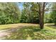 Large cleared space in the backyard, surrounded by trees, offers lots of potential at 197 Country Routt Brown Rd, Pittsboro, NC 27312