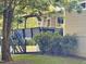 Backyard view featuring an elevated deck with stairs, mature trees, and well-manicured landscaping at 197 Country Routt Brown Rd, Pittsboro, NC 27312