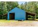 Spacious blue barn with open sides for storage and functionality at 197 Country Routt Brown Rd, Pittsboro, NC 27312