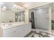 Bathroom featuring double vanity and large tile shower with pebble floor and modern fixtures at 197 Country Routt Brown Rd, Pittsboro, NC 27312